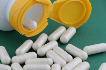 A stack of herbal capsule, dietary supplement, vitamin tablet, herbal medicine