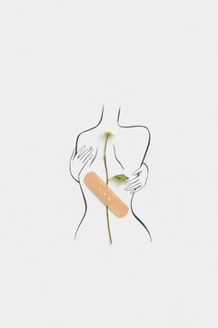 Hand drawn female body with daisy fixed on back with plaster