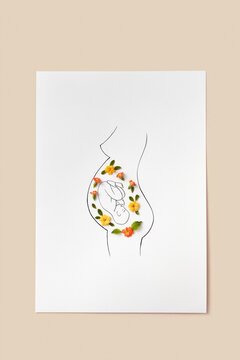 Line art of pregnant woman with unborn baby decorated with flowers