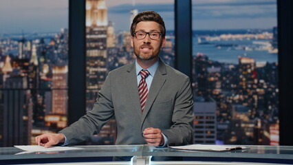 Newscaster presenting breaking news in evening television closeup. Man reporting