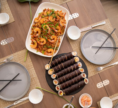 Asian meal table setting with sushi and rice
