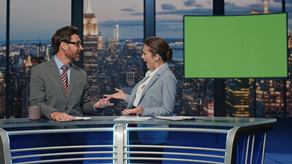 Charismatic tv hosts discussing mockup news evening closeup. Reporters talking