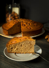 Piece of almond cake served on a plate. Macro view. Still life