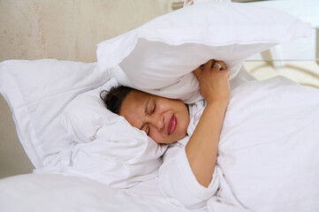 Unhappy woman having difficulties to wake up in the morning.