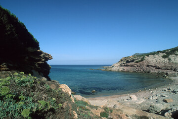 coast of island, beach with sky, Rocky shore. Bay of Porto Ferro. Sardinia, Italy.