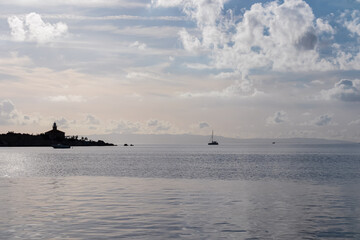 Scenic sunset view of Dalmatian archipelago seen from coastal town Makarska, Split-Dalmatia, Croatia, Europe. Silhouette of lighthouse. Coastline of Makarska Riviera, Adriatic Sea. Balkans in summer