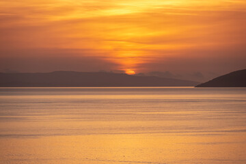 Naklejka premium Idyllic sunset view of Dalmatian archipelago seen from coastal town Makarska, Split-Dalmatia, Croatia, Europe. Silhouette of islands. Coastline of Makarska Riviera, Adriatic Sea. Balkans in summer