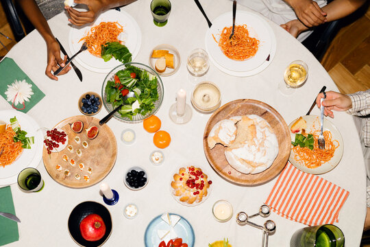 friends share food during Christmas dinner