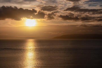 Idyllic sunset view of Dalmatian archipelago seen from coastal town Makarska, Split-Dalmatia, Croatia, Europe. Silhouette of islands. Coastline of Makarska Riviera, Adriatic Sea. Balkans in summer