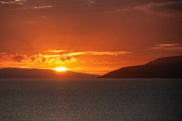 Idyllic sunset view of Dalmatian archipelago seen from coastal town Makarska, Split-Dalmatia, Croatia, Europe. Silhouette of islands. Coastline of Makarska Riviera, Adriatic Sea. Balkans in summer