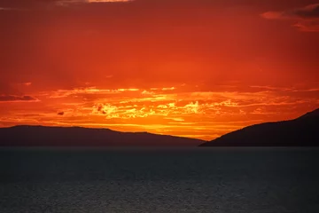 Poster Idyllic sunset view of Dalmatian archipelago seen from coastal town Makarska, Split-Dalmatia, Croatia, Europe. Silhouette of islands. Coastline of Makarska Riviera, Adriatic Sea. Balkans in summer © Chris