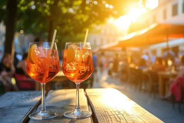 Foto op Plexiglas Two glasses of Aperol Spritz cocktails on the table in Italian restaurant, street view © Martinesku
