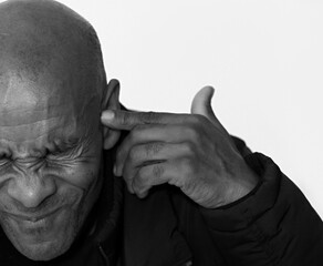 deaf man suffering from deafness and hearing loss on grey background with people stock photo	