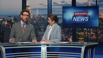Elegant newscasters presenting news evening television closeup. Hosts reporting - obrazy, fototapety, plakaty