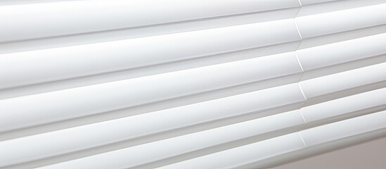 Obraz premium A close up of a grey metal blind with a wood pattern on a rectangular window. The blind has tinted shades and wire pipes for adjustment