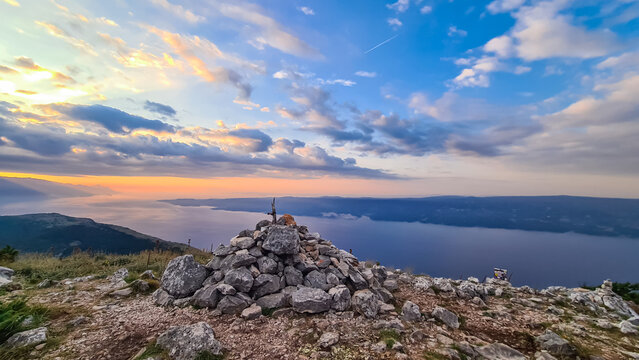 Wooden summit cross on top of mount Kula near Omis, Dinara mountains, Split-Dalmatia, Croatia, Europe. Majestic coastline Makarska Riviera, Adriatic Sea in Balkans in summer. Biokovo mountain range