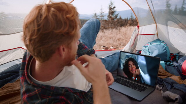 Tourist chatting laptop online with girl closeup. Relaxed man talking by web cam