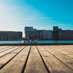 wooden quay with indistinct buildings in the background