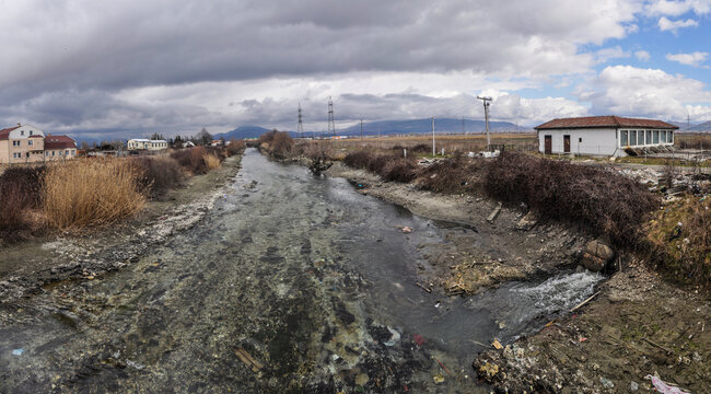 Major pollution of the waters of the river Crn Drim at the exit from tourist place Struga. Untreated water from the treatment plant flows into. The water level has been lowered by a nearby dam.
