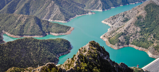 Blue green Kozjak lake surrounded by hills in the mountains of Macedonia. Large artificial lake. Breathtaking panoramic view.
