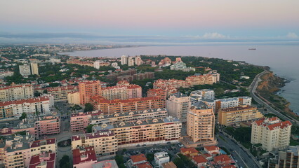 Obraz premium Evening scenery coastal town aerial view. Buildings on picturesque waterfront