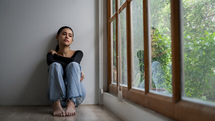 Fototapeta na wymiar Depressed young Asian woman with mental health problem in mind need uttermost treatment from overthinking fatigue, disruptive thought, dissocial, anxiety and other mental health disorders .