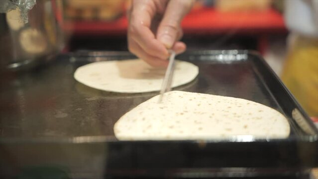 Chef cook warming a tortilla