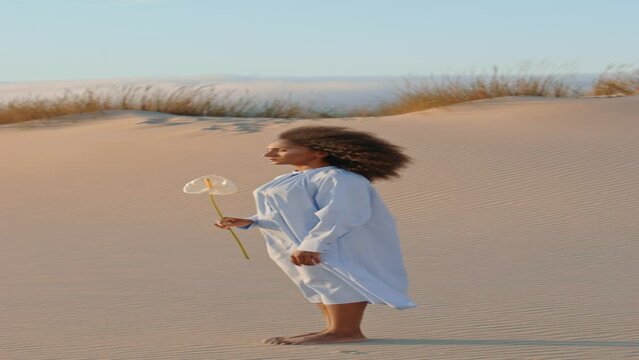 Actor woman posing sand desert with white flower day vertically. Girl with calla