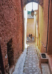 Narrow alley in historic Roussillon town, France - obrazy, fototapety, plakaty