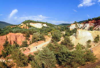 Fototapeta premium Tourists on Ochre trail called Provencal Colorado in Rustrel town, Provence, France