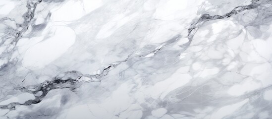 A closeup of a white marble texture on a white background resembling the fluidity of freezing water. The monochrome photo captures the beauty of this meteorological phenomenon