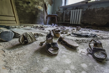Old shoes in Hospital MsCh-126 in Pripyat ghost city in Chernobyl Exclusion Zone - obrazy, fototapety, plakaty