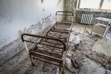 Patient room in maternity ward of hospital MsCh-126 in Pripyat ghost city in Chernobyl Exclusion Zone, Ukraine - obrazy, fototapety, plakaty