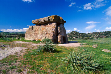Dolmen sa coveccada Mores Sardinia Italy on a sunny day against blue sky - obrazy, fototapety, plakaty