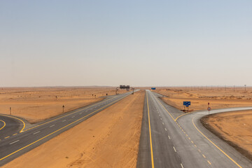 Fototapeta na wymiar Highway 15 through desert near Al Muthallth, Saudi Arabia
