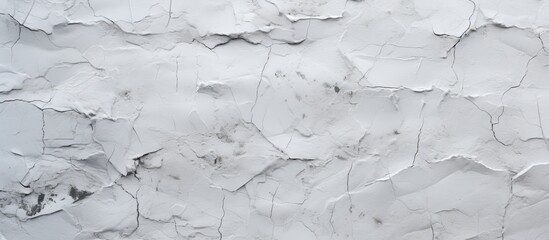 Obraz premium A closeup shot of a white wall with a marble texture resembling a freezing snowy landscape. The monochrome pattern creates a grey and wood flooring effect