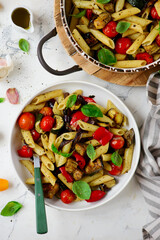 Roasted vegetables pasta with zuccini, tomato  and Basil  .top veiw.selective focus