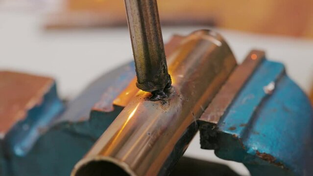 Close-up of welding torch fusing metal with sparks flying.