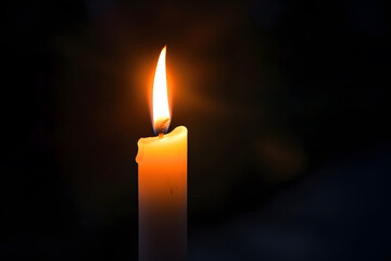 One lit candle on dark background - 759249842