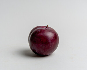 juicy red plums on white background