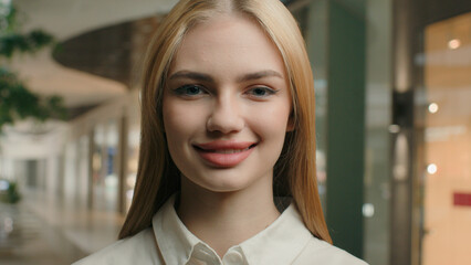 Close up portrait smiling Caucasian girl woman 20s young gen z lady shop assistant manager office...