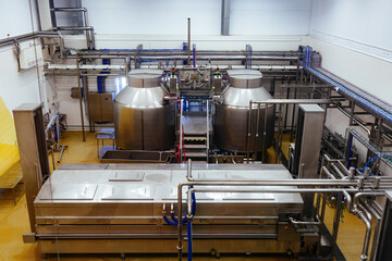Modern cheese factory, stainless steel milk processing tanks