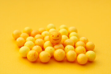 Happy yellow sphere over others without expression