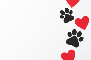 Pet paws on white background, dog paws pattern. National Puppy Day creative concept, top view