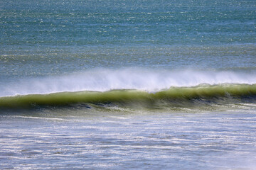 offshore breeze blowing against incoming waves