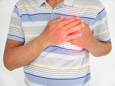 Asian man having severe chest pain as heart attack and illness concept on white background. closeup photo, blurred.