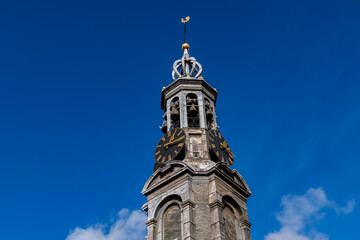 Fototapeta na wymiar Fragment of Amsterdam Mint Tower (or Munttoren, 1620) at Muntplein square near flower market. Munttoren was originally part of gate in Amsterdam's medieval city wall. Amsterdam, the Netherlands.