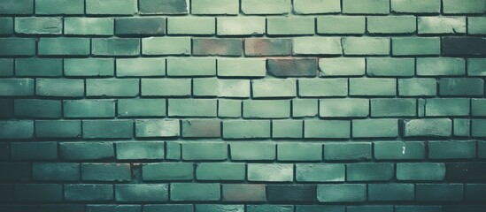 Detailed close up of a rectangular green brick wall showcasing intricate brickwork patterns. The textured surface adds character to the building or road surface