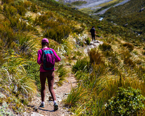 hiker girl enjoys a scenic path in southern alps - otira valley track in canterbury, new zealand...