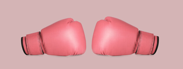 Breast cancer. Pair of pink boxing gloves on color background, banner design